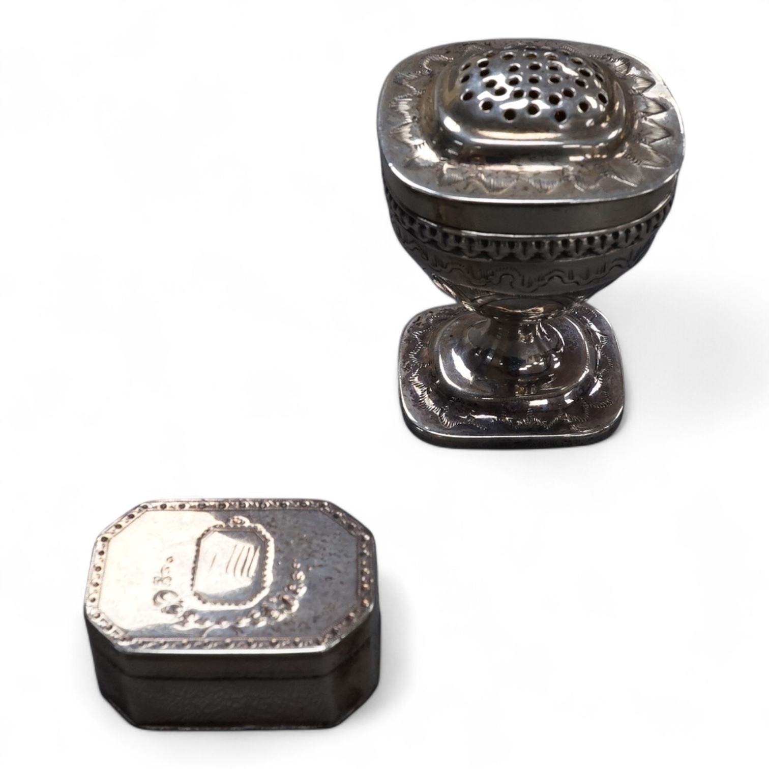 A George III silver octagonal nutmeg grater by Phipps & Robinson, London, 1810, 46mm(a.f.), together with a George III silver pedestal pepperette, by Alice & George Burroughs, London, 1808, 70mm.